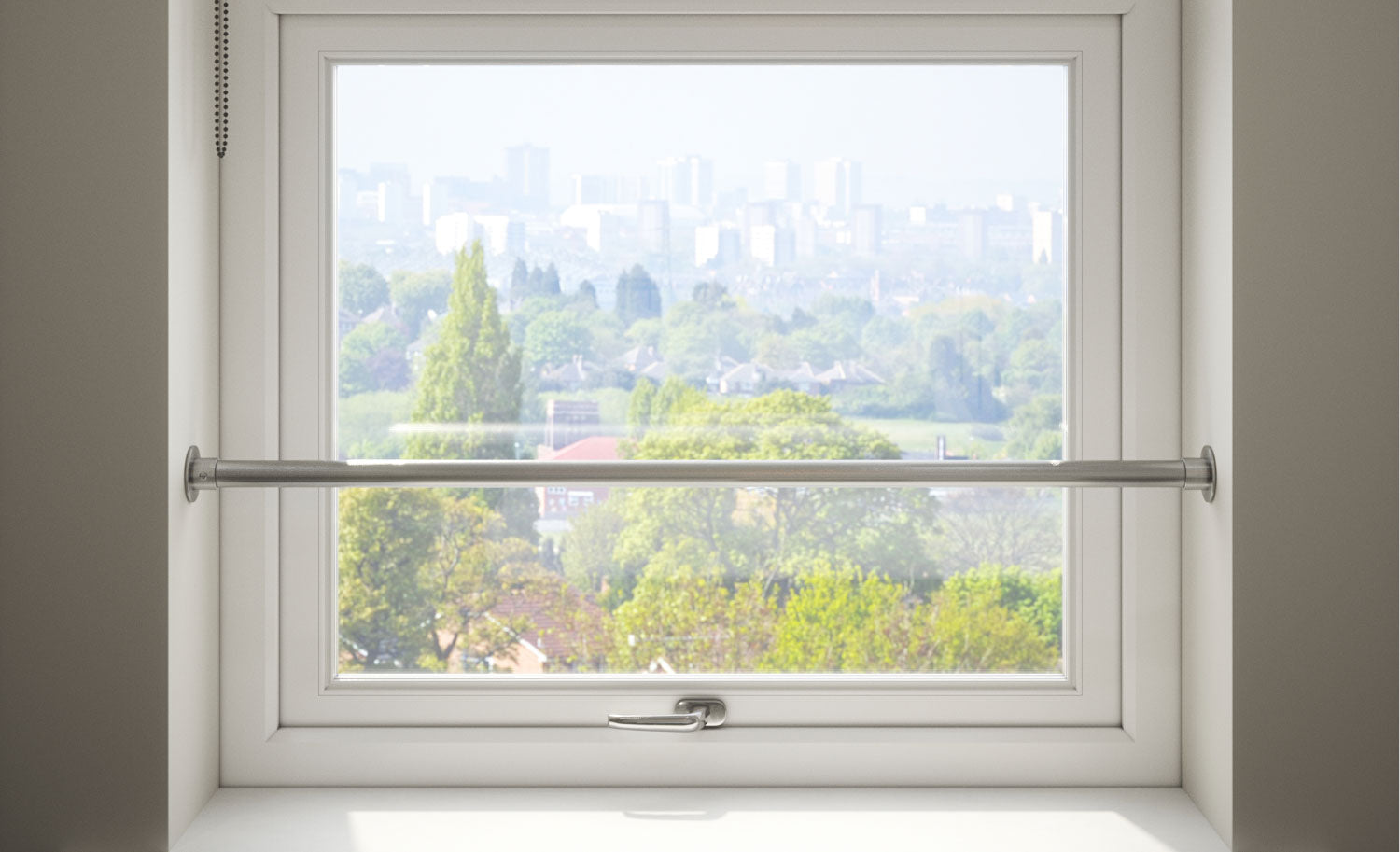 Interior view of upstairs window fitted with Rothley Window Safety Barrier Kit, looking out over trees and buildings